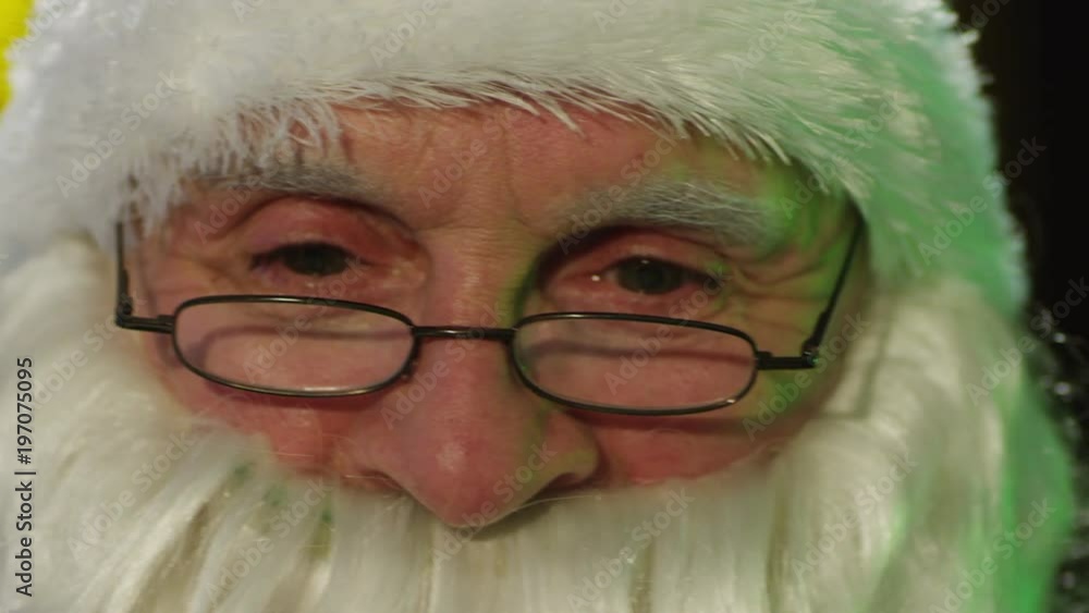 Close-up portrait of Santa Claus working, thinking, and demostraiting many emotions. Shot on RED Cinema Camera. Close-up portrait of Santa Claus working, thinking, and demostraiting many emotions. Shot on RED Cinema Camera.
