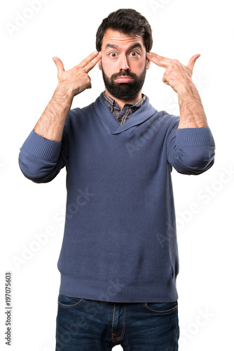 Handsome brunette man with beard making suicide gesture on white background
