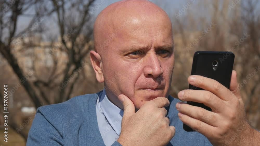 Concerned Businessman Read Bad News Using Cell Internet Connection Concerned Businessman Read Bad News Using Cell Internet Connection