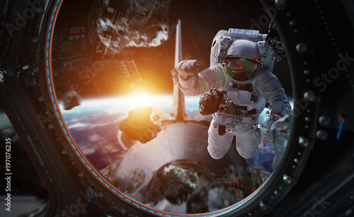 Fototapeta Naklejka Na Ścianę i Meble -  Astronaut working on a space station 3D rendering elements of this image furnished by NASA