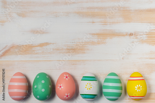 Colorful easter eggs on wooden background. Easter concept.