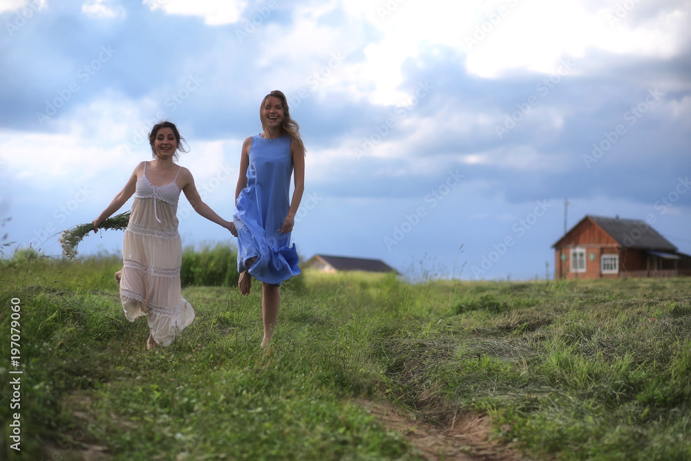 Young girls are walking in the field Young girls are walking in the field