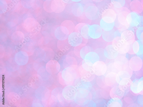 Bright and abstract blurred pink,light blue, violet and white background with shimmering glitter. Defocused unique bokeh festive lights. Colorful bright light texture of circular points