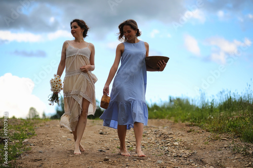 Two girls in dresses in summer field © alexkich