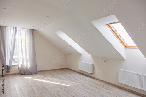 A window in the attic. Sunny morning. Light in the window.