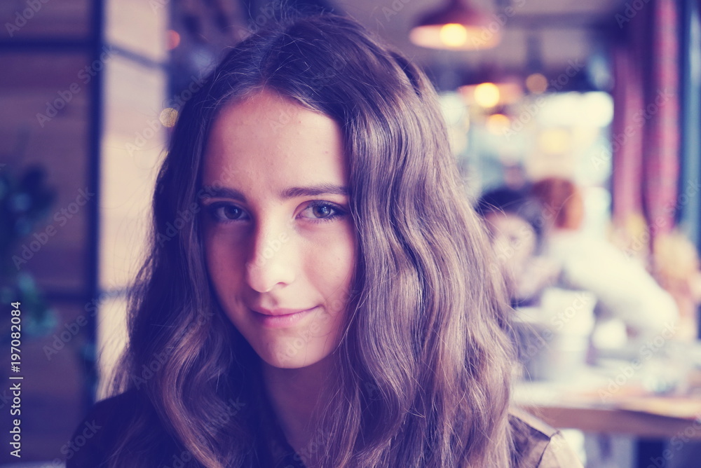 Portrait of a pretty looking girl with long brown hair