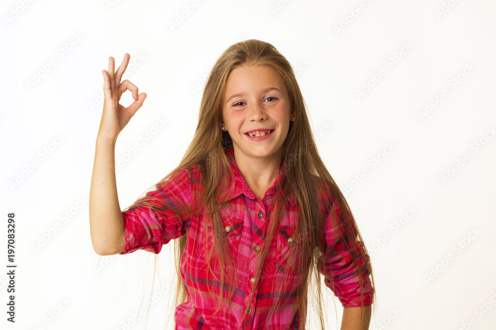 Young beautiful little girl smiles showing hand ok sign over white background Young beautiful little girl smiles showing hand ok sign over white background
