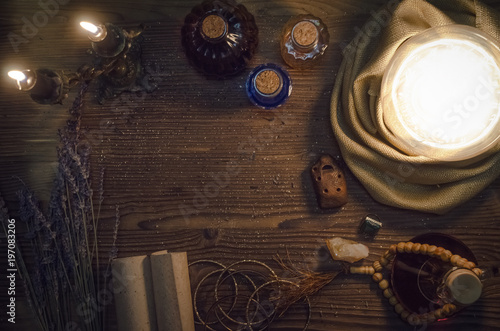 Fotografija Crystal ball and ancient magic scrolls on fortune teller magic desk table background