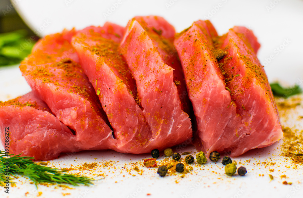 Pork fillet chopped spices on a white background. Pork fillet chopped spices on a white background.