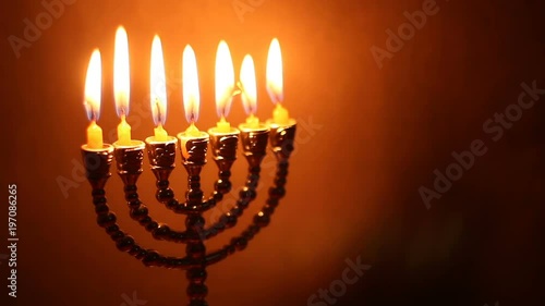 Flame of menorah on the dark background