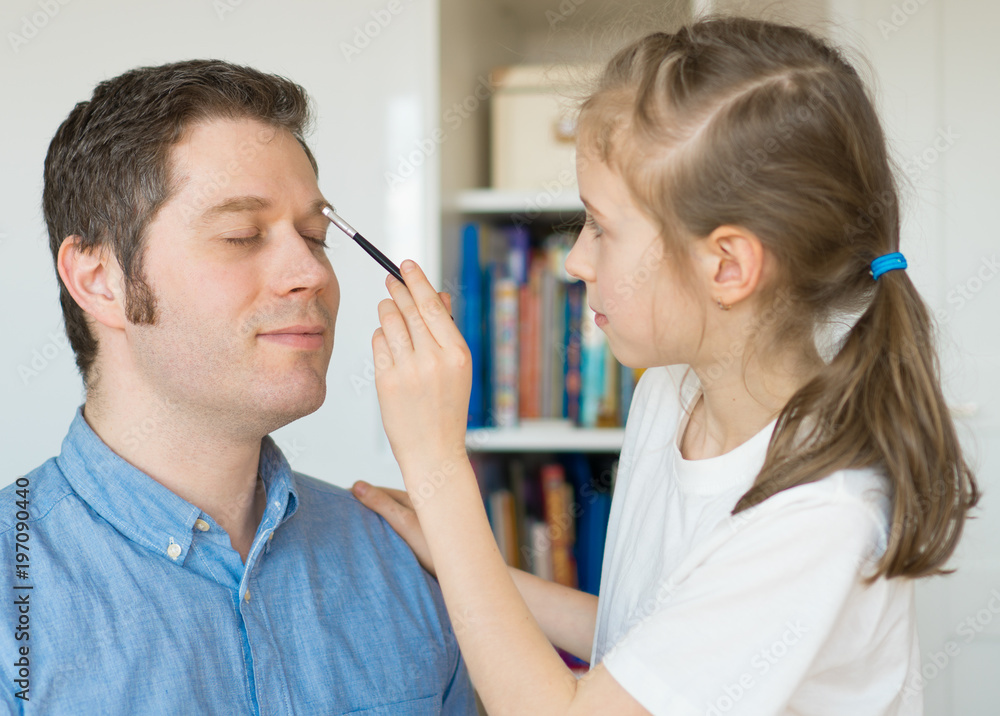 Cute little girl making makeup to her dad. Cute little girl making makeup to her dad.