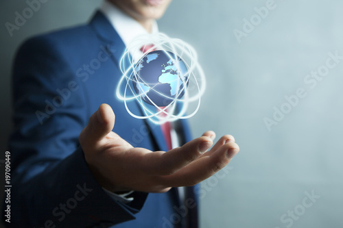 Businessman holding digital globe world in screen