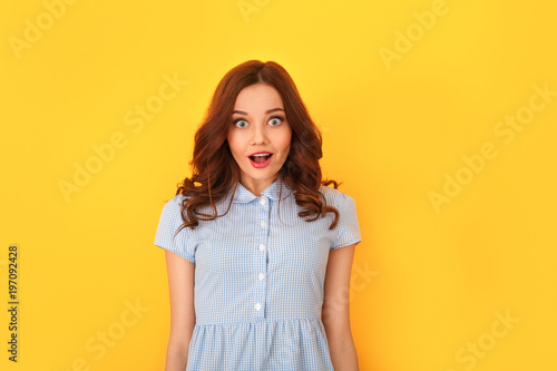 Young woman studio isolated on yellow looking camera shocked © Viktoriia