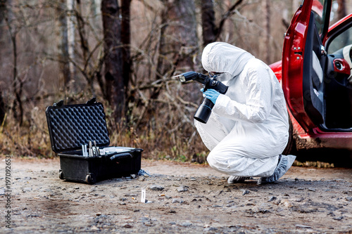 expert collecting evidence at the crime scene. Law and police concept photo
