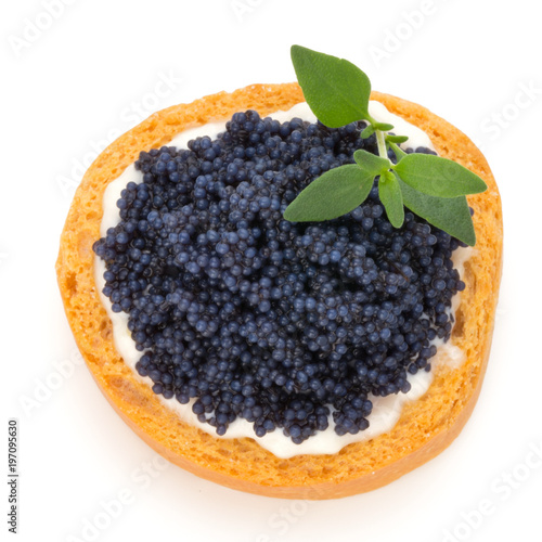 Canapes with black sturgeon caviar and  spice isolated on the white background.