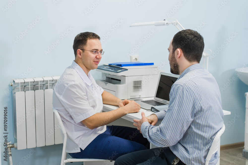 Fototapeta premium Doctor smiling and talking to patient in office