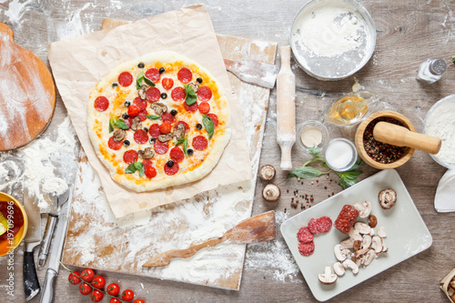 Top view cooking pizza with...