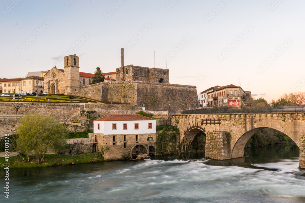 Landscape of the city of Barcelos, district Braga, Portugal. Landscape on the river Cávado, Barcelos bridge, Paço dos Condes, water mill and church. Buildings all in stone and old wi