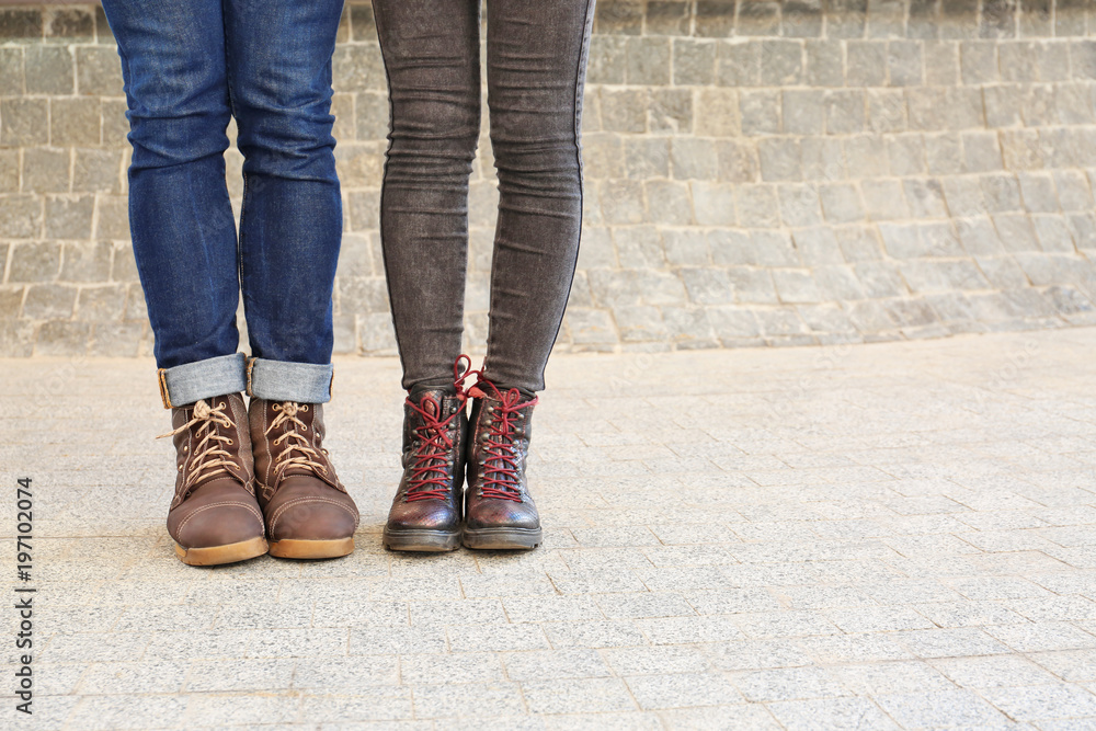 Stylish couple in comfortable shoes on city street Stylish couple in comfortable shoes on city street