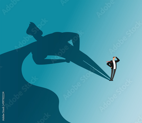 Businessman with superhero shadow. Ambition and business success vector concept photo