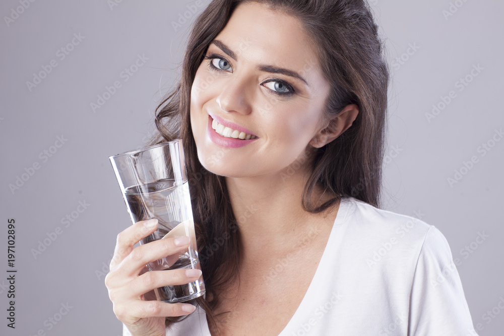 Young woman with beautiful smile is drinking water. Young woman with beautiful smile is drinking water.