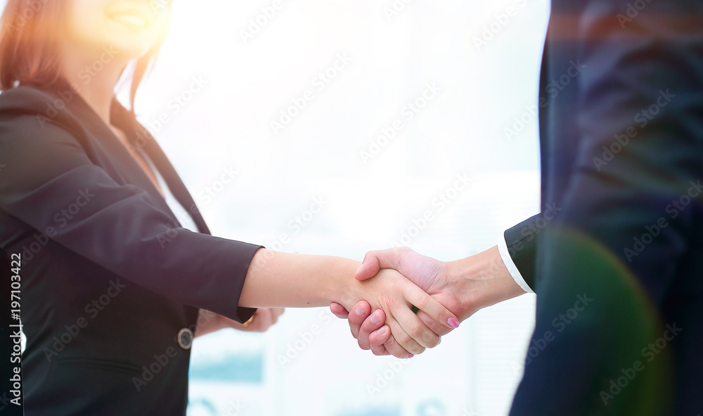 business colleagues shaking hands after a successful presentation.