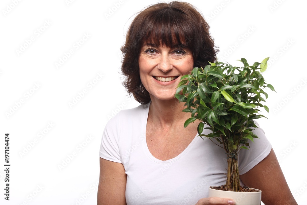 Mature woman with a plant