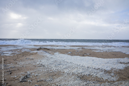beach with sea foam before the storm Carmen hits the coast of La Faute Sur Mer, Vendee, France