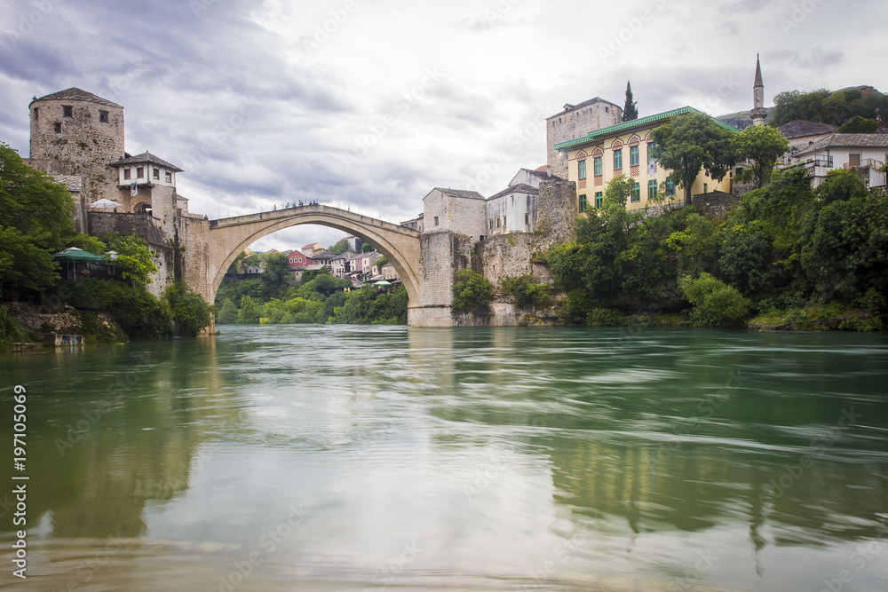 View of the single-arch Old Bridge or Stari Most Neretva over River in Mostar, Bosnia and Herzegovina. The Old Bridge was destroyed in 1993 by Croat military forces during the Croat–Bosniak War. 