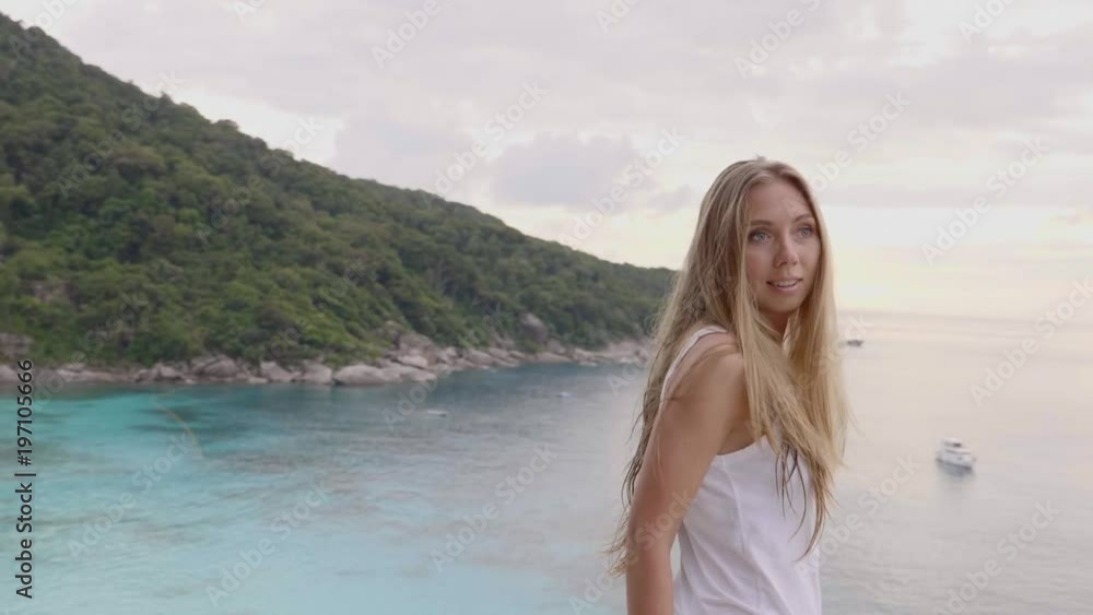 Woman stands on the top of mountain peak with sea and tropical island view and enjoy the beautiful outdoor landscape. Travel, freedom, vacation and happiness concept. Woman stands on the top of mountain peak with sea and tropical island view and enjoy the beautiful outdoor landscape. Travel, freedom, vacation and happiness concept.