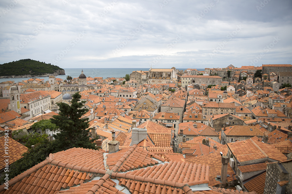 View over the orange rooftops of old town Dubrovnik from the ancient city wall with cloudy weather, Croatia