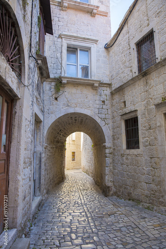 cobblestone street with an arch passage in old town Split  Croatia