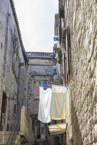 Mediterranean picture od linen drying between buildings in a street of Trogir, Croatia © Melanie