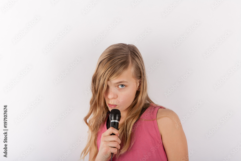 Young cute girl holding a microphone singing karaoke Young cute girl holding a microphone singing karaoke