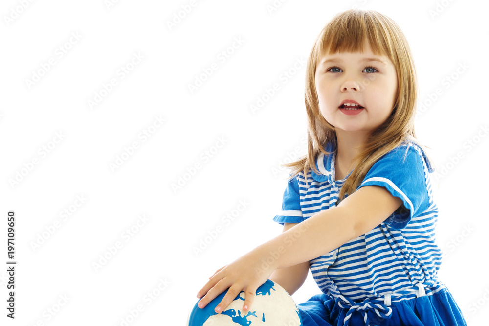 A little girl looks at the Globe. A little girl looks at the Globe.