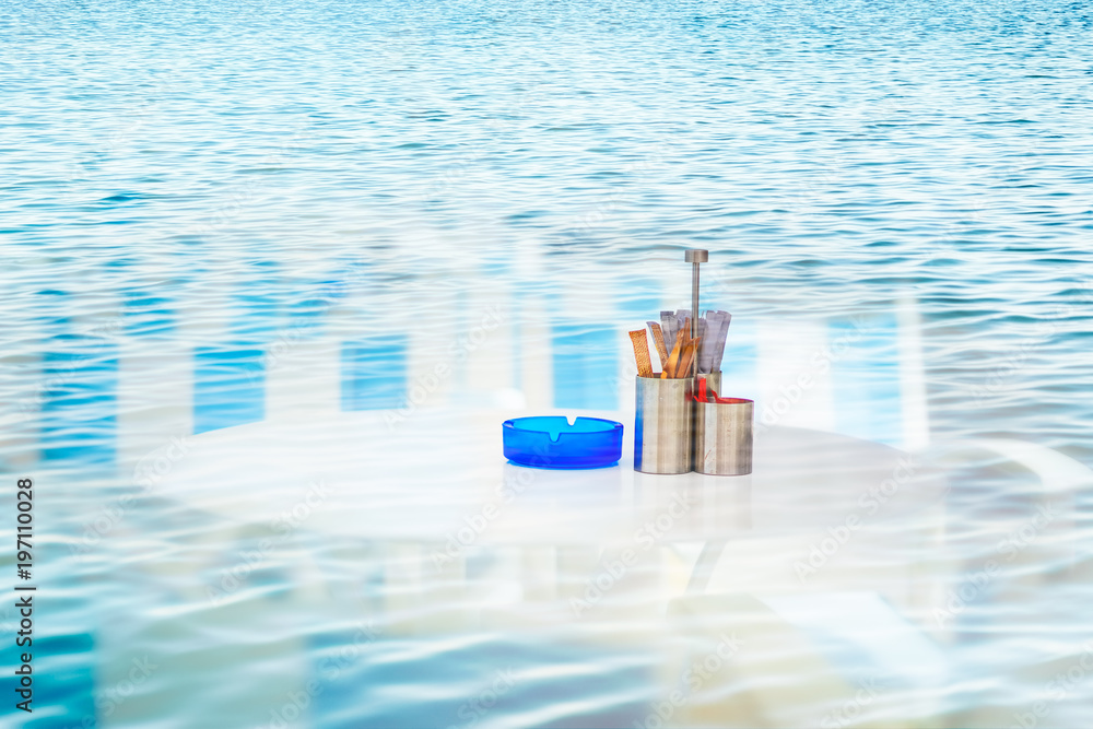 Double exposure of white table and blue water Double exposure of white table and blue water