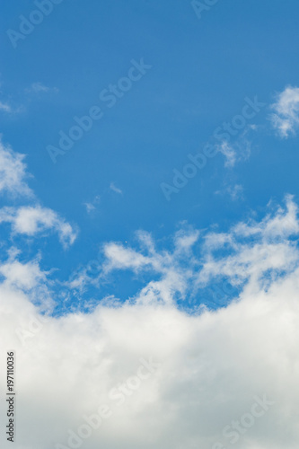 The vertical view of light blue sky with white clouds for background or texture. Copy space © Alex