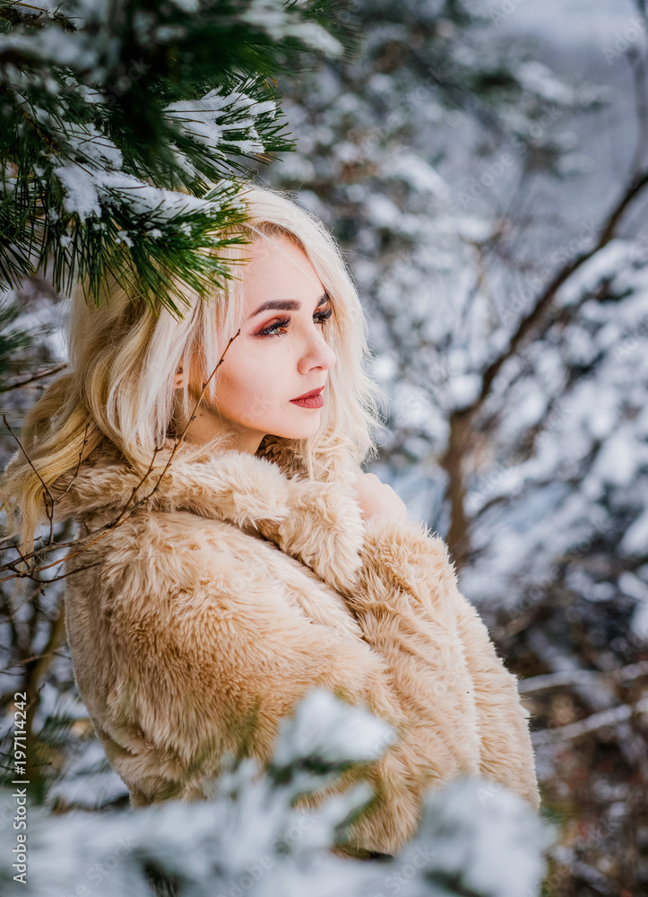 Awesome blonde girl posing between branches Awesome blonde girl posing between branches