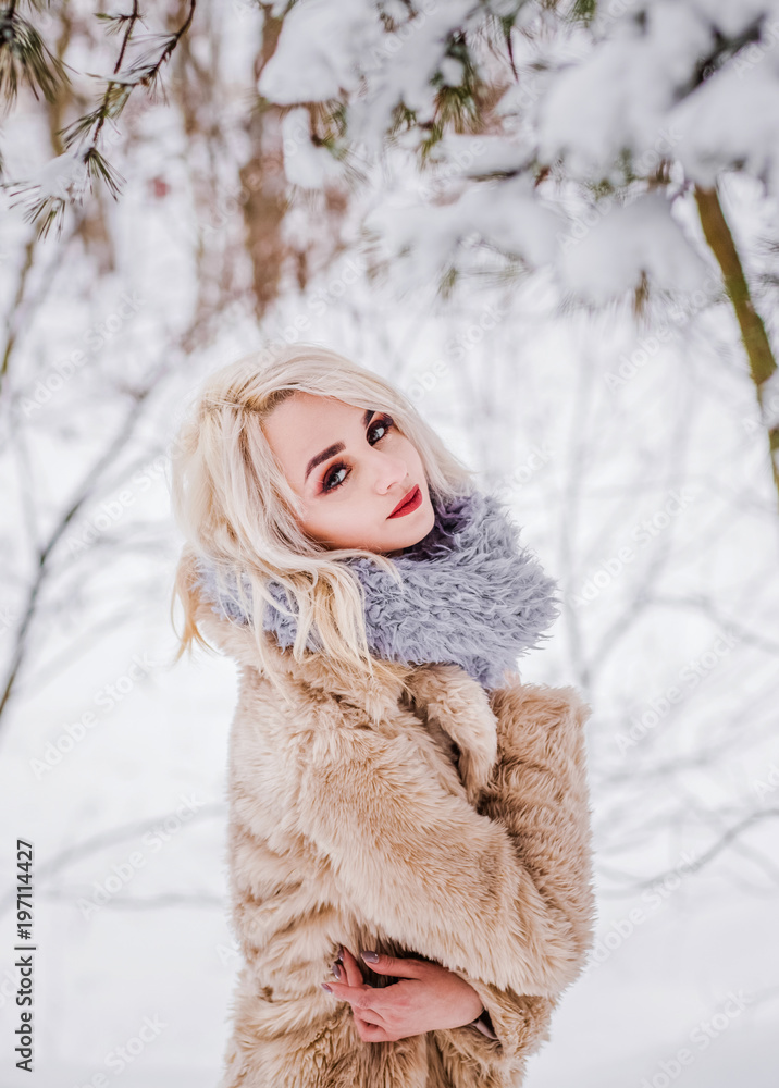 A charming woman standing under the tree A charming woman standing under the tree