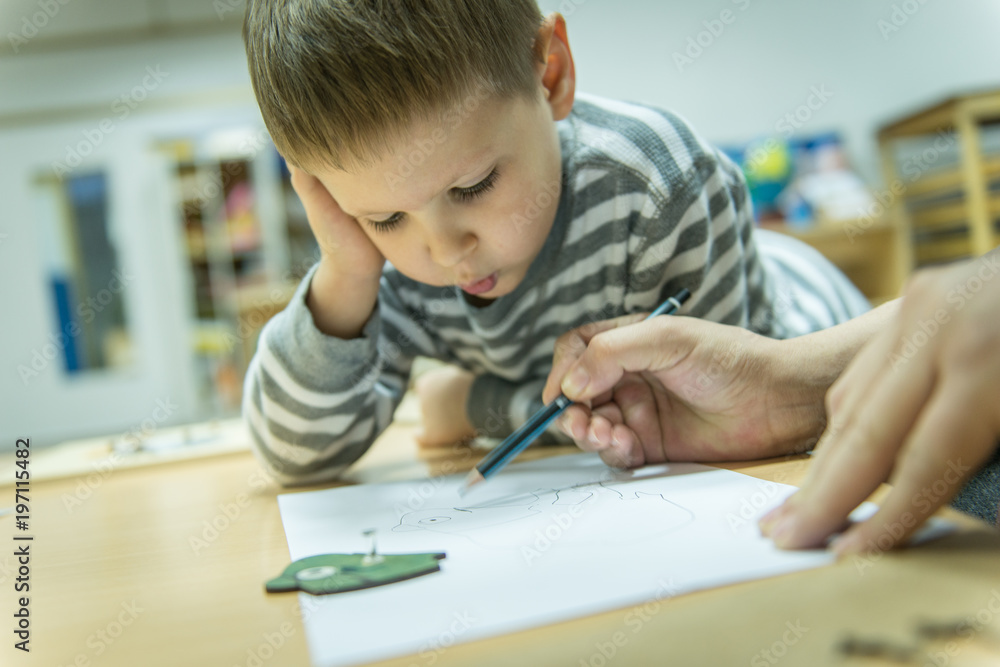 Caucasian boy toughtfully look how mum write Caucasian boy toughtfully look how mum write