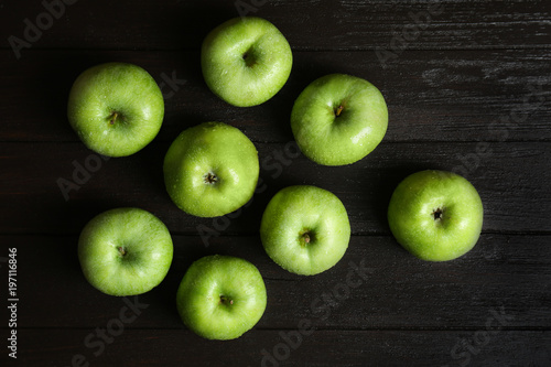 Fresh green apples on wooden background  top view