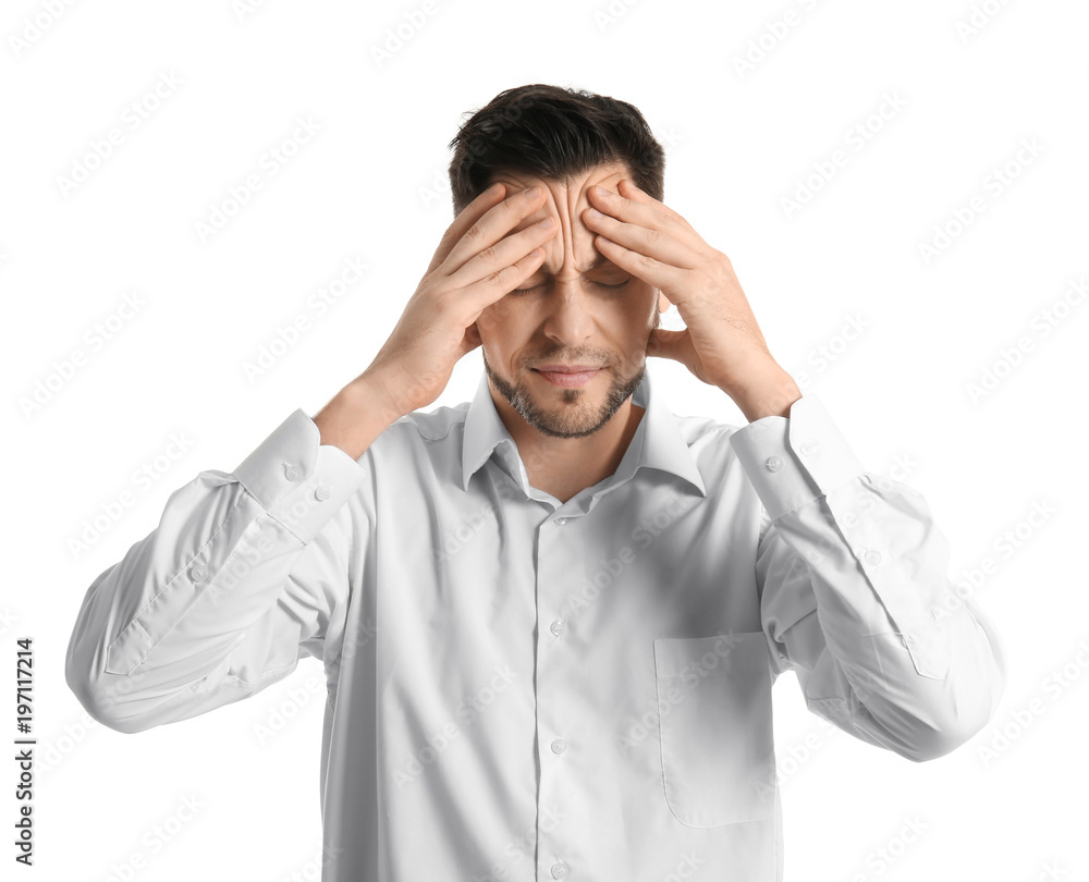 Naklejka premium Young man suffering from headache on white background