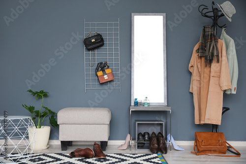 Stylish hallway interior with large mirror and coat rack photo