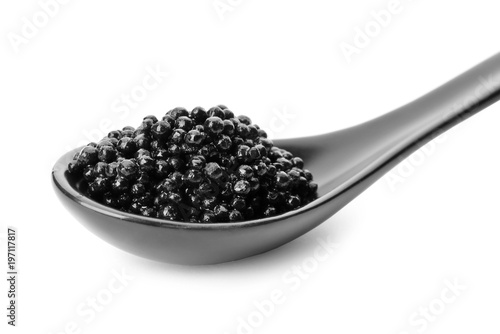Ceramic spoon with black caviar on white background