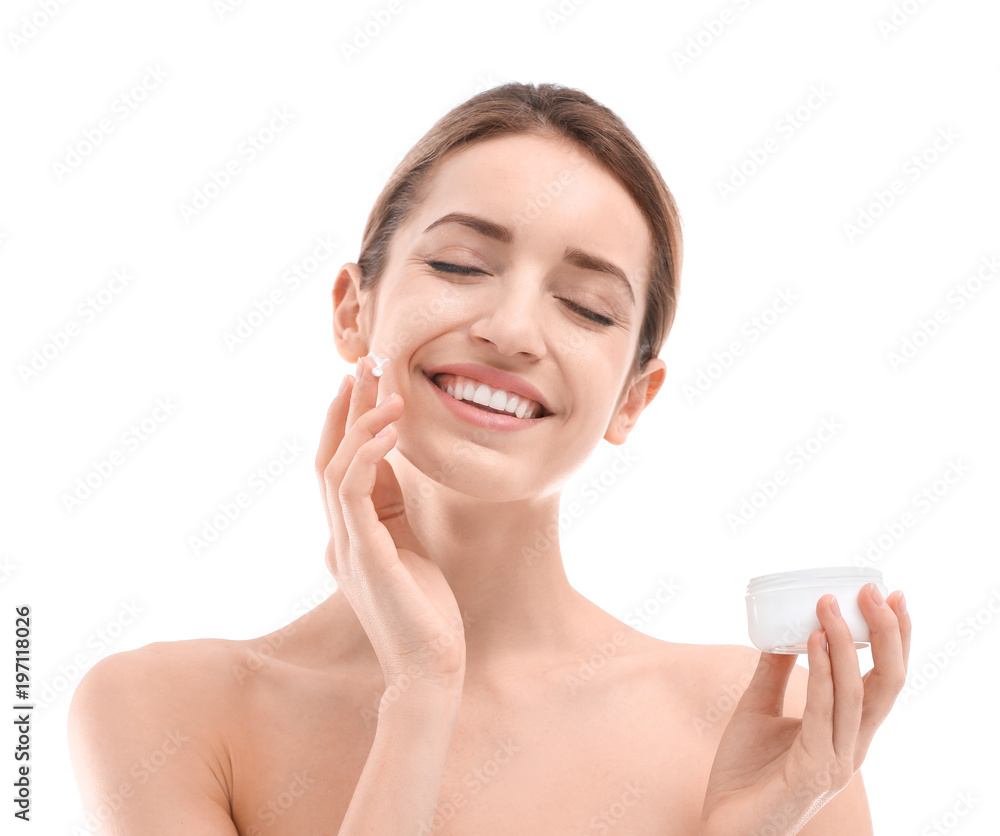 Young woman applying face cream on white background Young woman applying face cream on white background