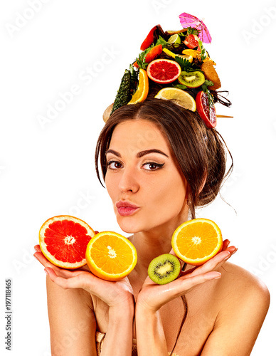 Hair mask from fresh fruits on woman head. Girl with beautiful face hold ingredient for homemade organic skin and hair therapy. Fruits are nicely laid out on palms. Selfie in spa salon.