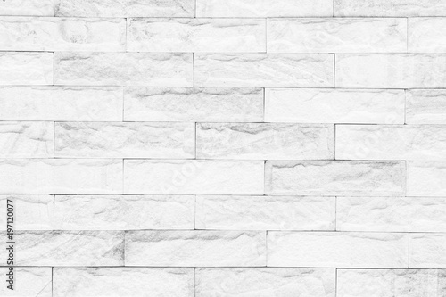 White brick wall texture background. Brickwork or stonework flooring interior rock old pattern clean concrete grid uneven bricks design stack.