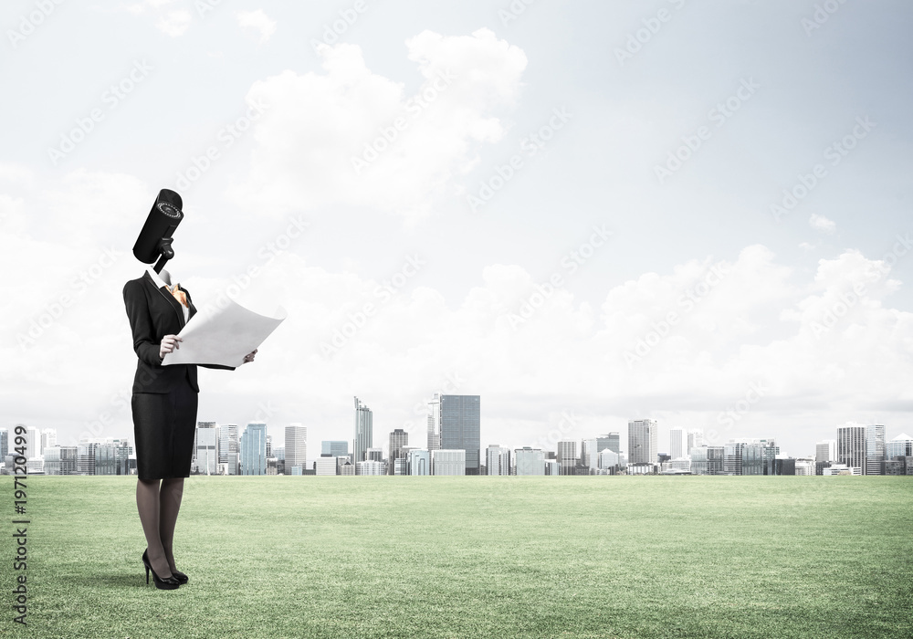 Camera headed woman standing on green grass against modern citys Camera headed woman standing on green grass against modern citys