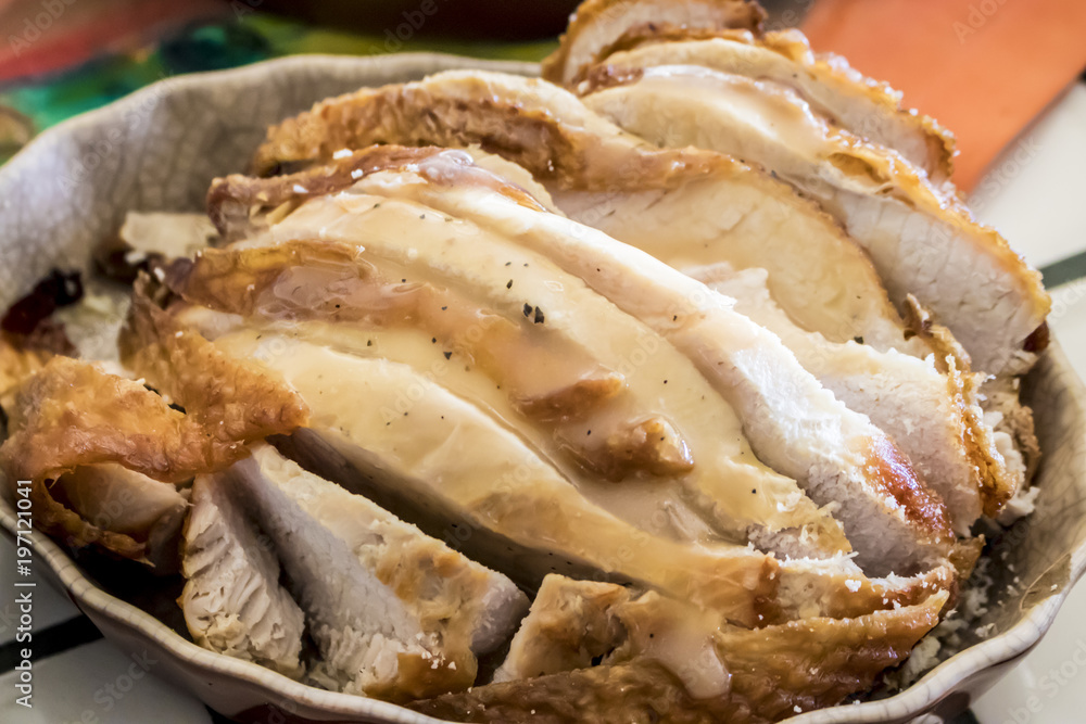 Closeup of Turkey Covered with Gravy in a Serving Dish