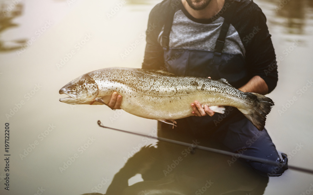 Obraz premium Man caught salmon fish